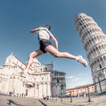 athletic young man is running at the Pisa tower