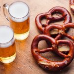 Beer and Salted Pretzels on Wooden Table Background. Close up.