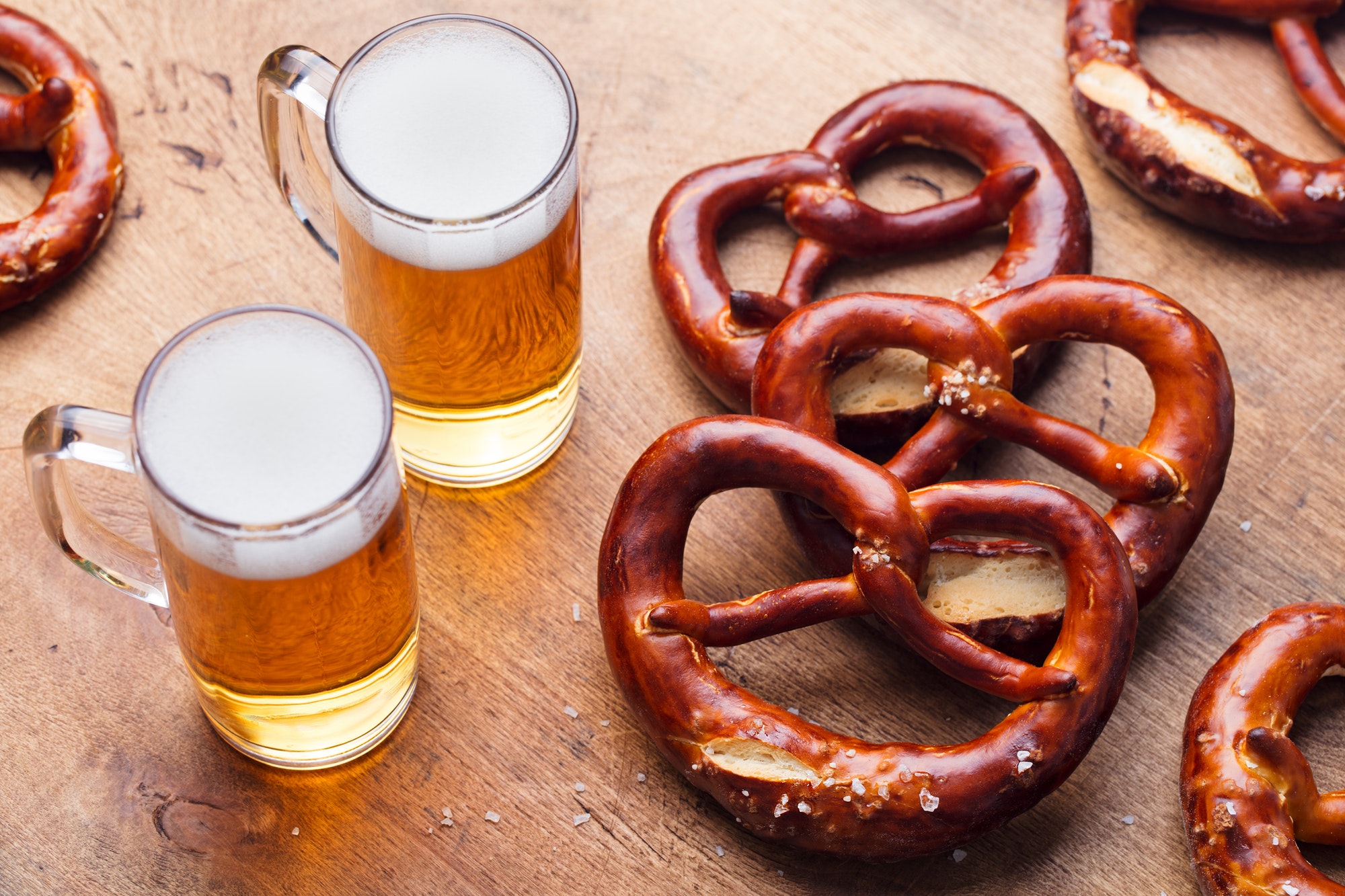 Beer and Salted Pretzels on Wooden Table Background. Close up.
