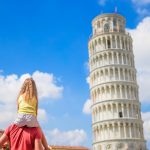 Family of dad and kid background the Learning Tower in Pisa. Pisa - travel to famous places in