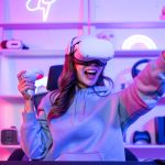 Asian young esport woman gamer use technology VR glasses and play game.