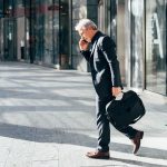 middle age business man outdoors talking smartphone