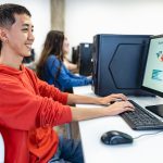 Young multiracial students taking exams in high school - Education and technology concept