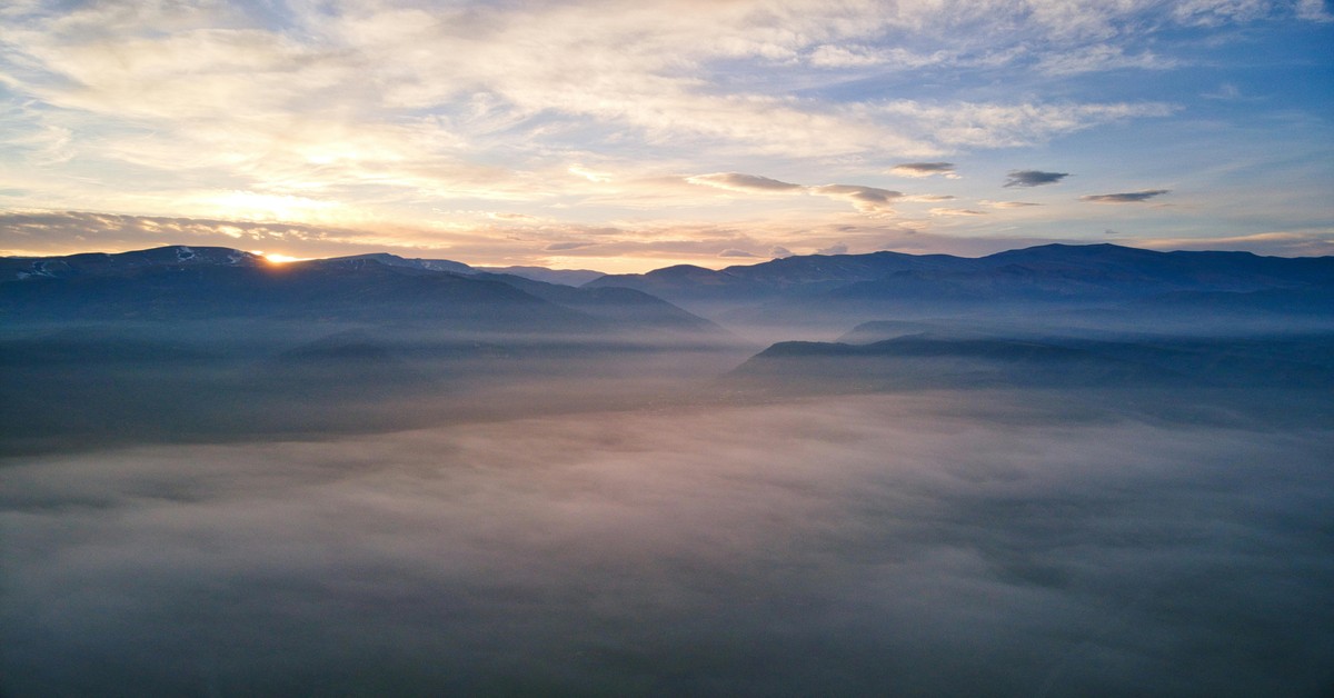 Misty morning over the Apennine mountains in Abruzzo, Italy, with rolling hills and forests